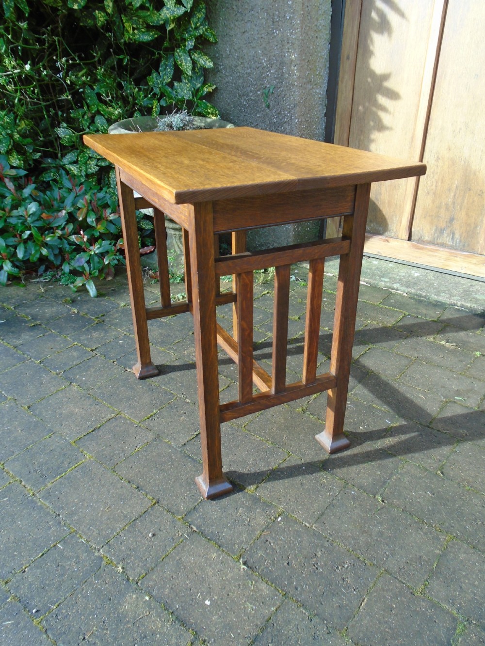 A rectangular Arts and Crafts oak side table featuring slatted side stretchers, square legs with splayed feet, and a flat top. View IV