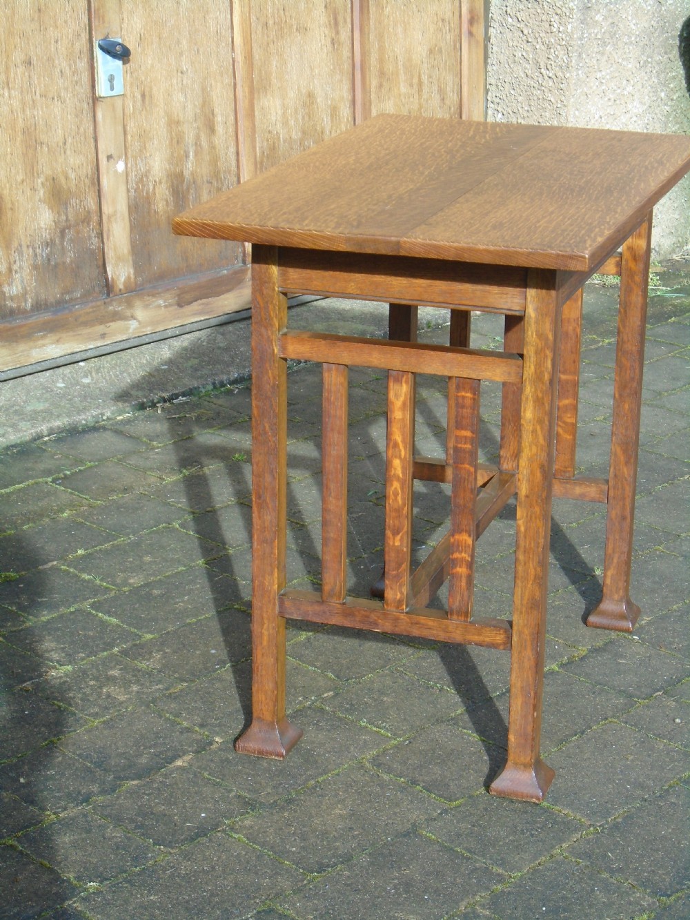 A rectangular Arts and Crafts oak side table featuring slatted side stretchers, square legs with splayed feet, and a flat top. View IX
