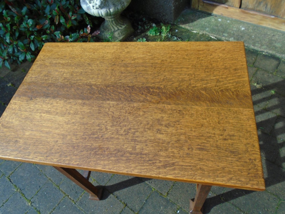 A rectangular Arts and Crafts oak side table featuring slatted side stretchers, square legs with splayed feet, and a flat top. View XI