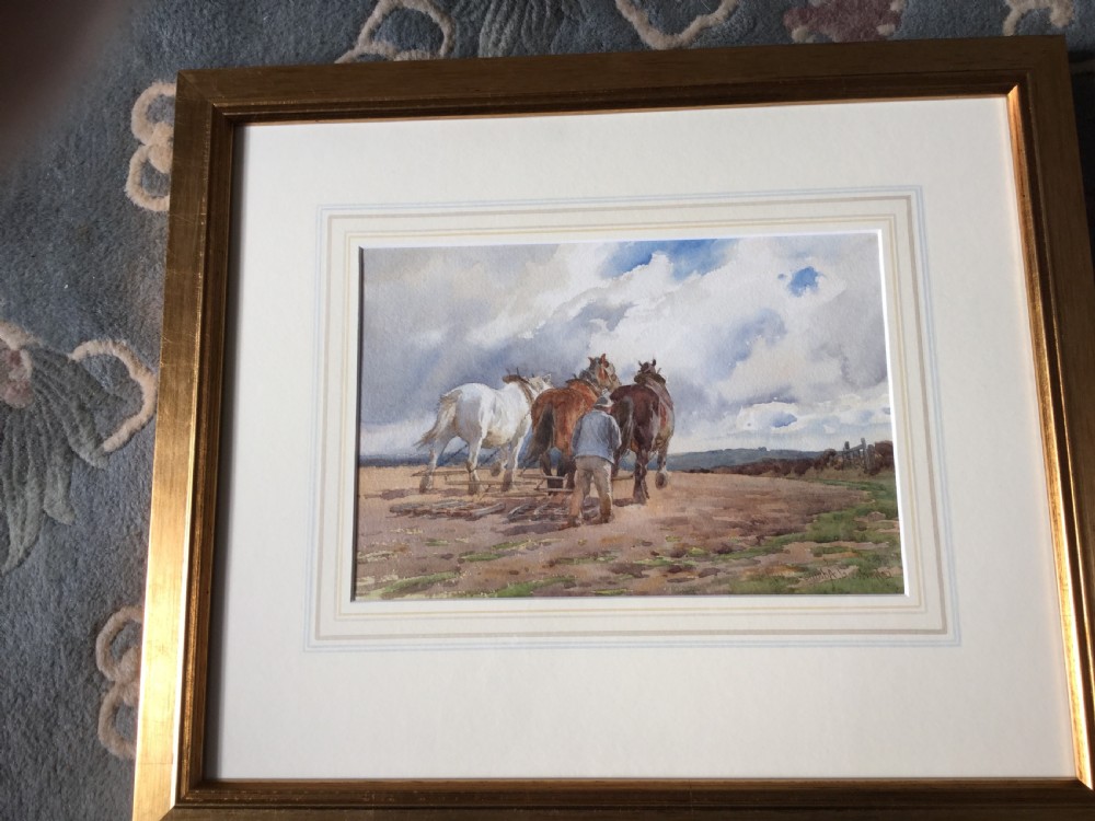 A watercolour painting signed by Charles James Adams depicting three heavy horses pulling an agricultural harrow across a field guided by a farmer under a cloudy sky. View II