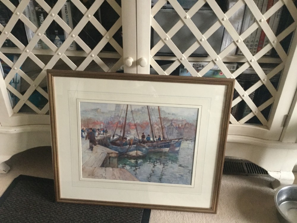 A late 19th-century watercolour painting depicting fishing boats docked at a harbour quay in Whitby with town buildings visible in the background. View III