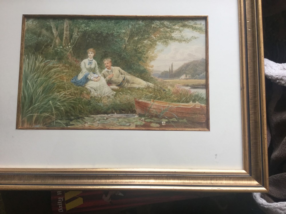 A Victorian watercolour painting depicting a man reclining and a woman seated on a grassy riverbank beside a small wooden boat. View II