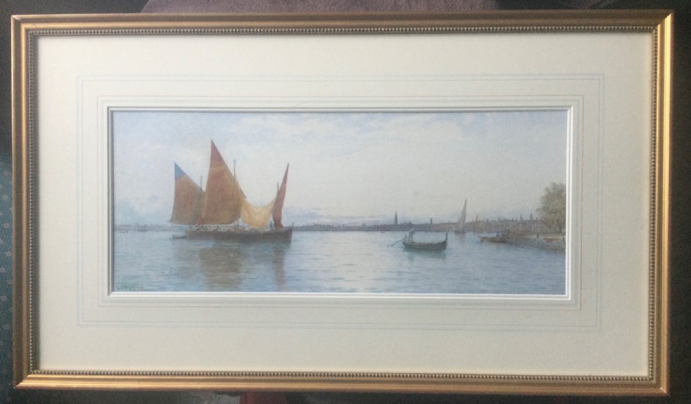 A horizontal watercolour painting depicting traditional sailing boats with terracotta and ochre sails on the Venetian lagoon with a distant skyline. View II