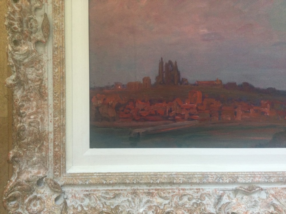 An impressionist oil painting depicting Whitby Abbey silhouetted against a twilight sky in shades of purple and pink, presented in an ornate carved frame. View II