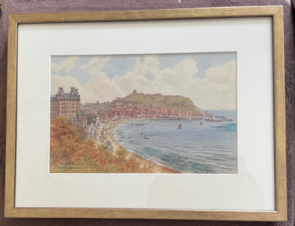 An antique watercolour landscape painting depicting South Bay in Scarborough, featuring the Grand Hotel, Scarborough Castle on the hill, a sandy beach, and boats in the sea, signed A.R.Q. in the lower right corner. View II