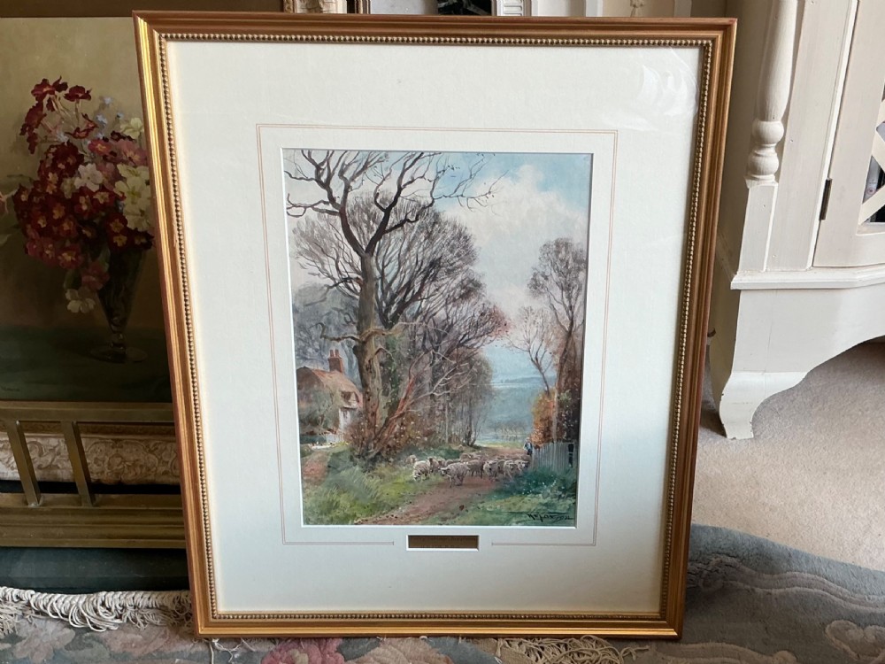 A Victorian watercolour painting depicting a shepherd guiding a flock of sheep along a tree-lined dirt track past a thatched cottage in Sussex. View II