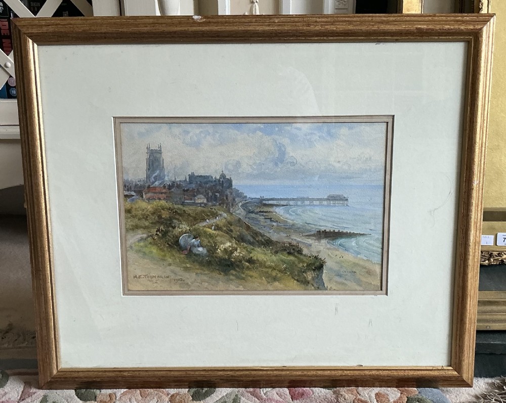 An early 20th-century watercolour painting depicting a coastal cliff top overlooking the beach, pier, and church tower of Cromer, signed and dated 1913 by H.E. Tidmarsh. View II