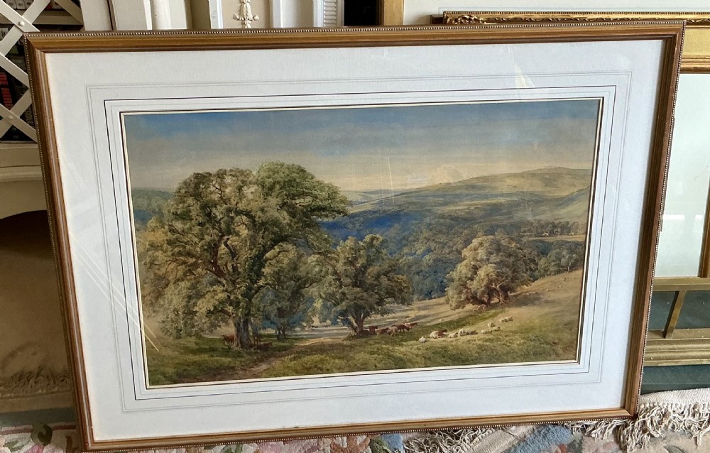 A detailed watercolour painting depicting a sweeping rural landscape with large leafy trees, livestock grazing in a pasture, and distant rolling hills. View II