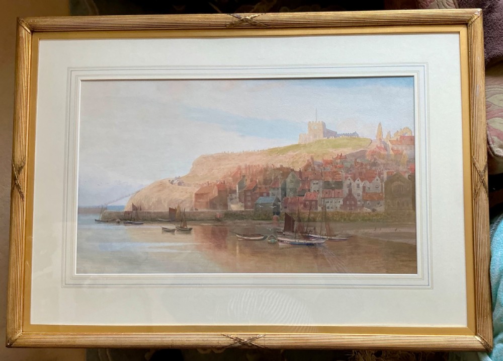 A nineteenth-century watercolour painting depicting Whitby harbour with fishing boats in the foreground and St Marys Church and Whitby Abbey positioned on the cliff top above red-roofed buildings. View II