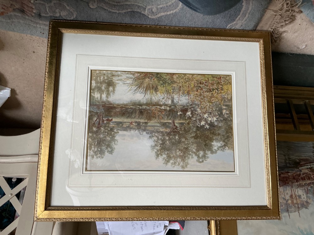 A late 19th-century watercolour painting depicting a river scene with tall flora in the foreground and cattle grazing in distant fields under a soft sky. View IV