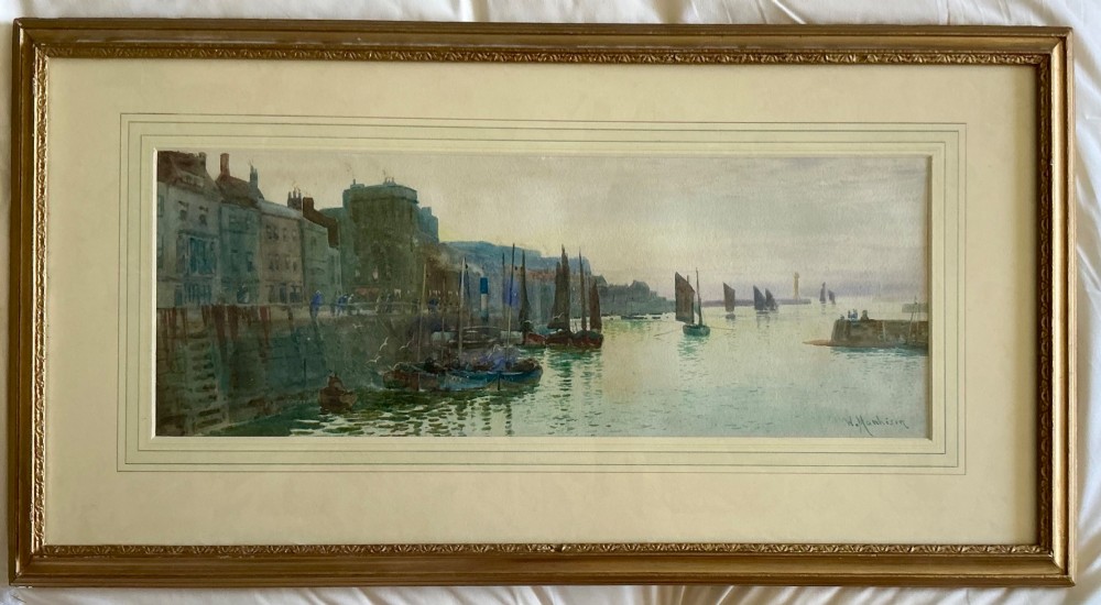 A watercolour painting depicting sailing boats in Whitby harbour against a backdrop of historic town buildings and a muted sky. View II