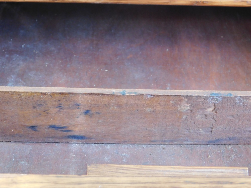 A Victorian oak writing table featuring two drawers with brass drop handles and curved leg braces. View II