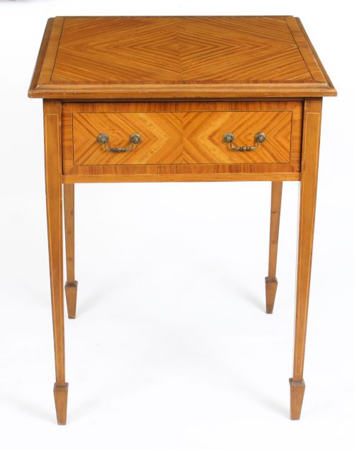 fig 1. A square Victorian satinwood occasional table featuring a single drawer with brass handles, chevron parquetry top, and four square tapered legs.