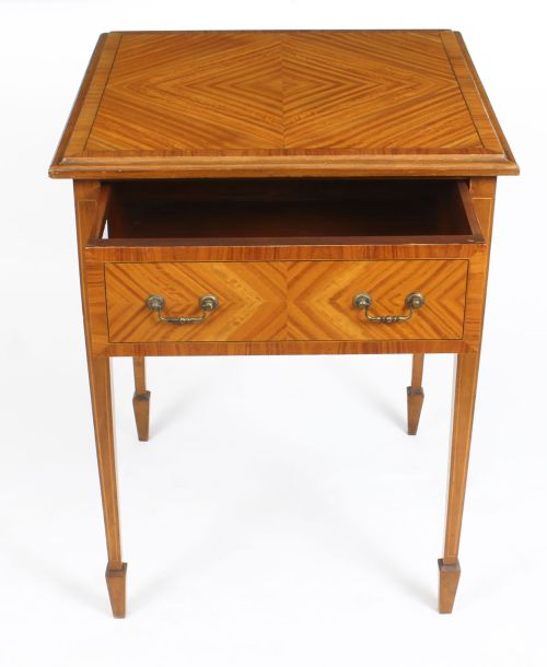 fig 4. A square Victorian satinwood occasional table featuring a single drawer with brass handles, chevron parquetry top, and four square tapered legs.