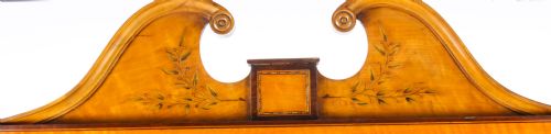 fig 2. An Edwardian satinwood cheval mirror featuring intricate marquetry inlay, an arched pediment with finials, side adjusters, and splayed legs with brass castors.