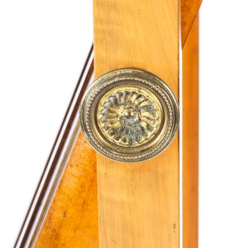 fig 6. An Edwardian satinwood cheval mirror featuring intricate marquetry inlay, an arched pediment with finials, side adjusters, and splayed legs with brass castors.