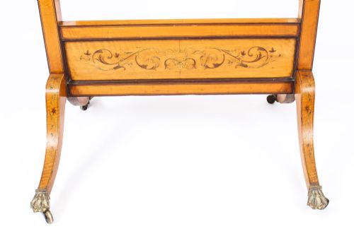 fig 7. An Edwardian satinwood cheval mirror featuring intricate marquetry inlay, an arched pediment with finials, side adjusters, and splayed legs with brass castors.