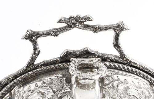 fig 3. An antique silver-plated folding biscuit box featuring two chased shell-shaped compartments mounted on a cast faux-branch frame.