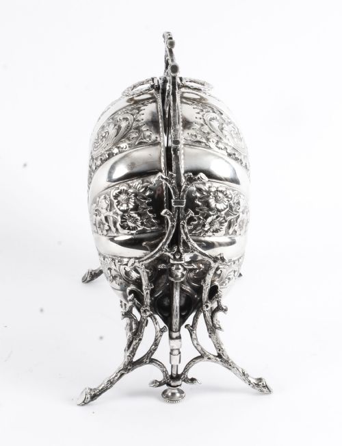 fig 8. An antique silver-plated folding biscuit box featuring two chased shell-shaped compartments mounted on a cast faux-branch frame.