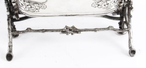 fig 9. An antique silver-plated folding biscuit box featuring two chased shell-shaped compartments mounted on a cast faux-branch frame.