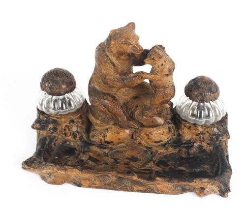fig 1. A 19th-century carved wood Black Forest inkstand featuring a mother bear and cub sitting on a naturalistic log base between two clear glass inkwells.