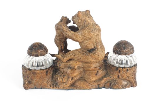 fig 5. A 19th-century carved wood Black Forest inkstand featuring a mother bear and cub sitting on a naturalistic log base between two clear glass inkwells.