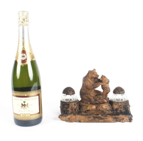 fig 7. A 19th-century carved wood Black Forest inkstand featuring a mother bear and cub sitting on a naturalistic log base between two clear glass inkwells.