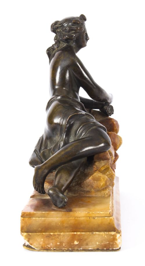 fig 4. A pair of 19th-century dark bronze sculptures depicting semi-nude classical reclining female figures set upon carved yellow marble bases.