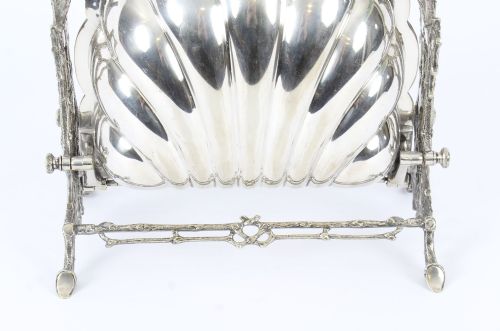 fig 3. An antique Victorian silver-plated folding biscuit box shaped like a double scallop shell suspended in a twig-form metal frame.