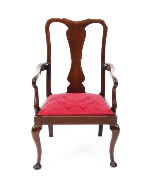 fig 1. A small dark mahogany Queen Anne style armchair with a vasiform back splat, curved arms, cabriole front legs, and a red damask upholstered seat.