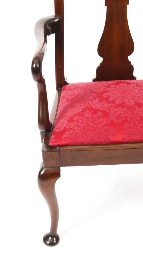 fig 4. A small dark mahogany Queen Anne style armchair with a vasiform back splat, curved arms, cabriole front legs, and a red damask upholstered seat.