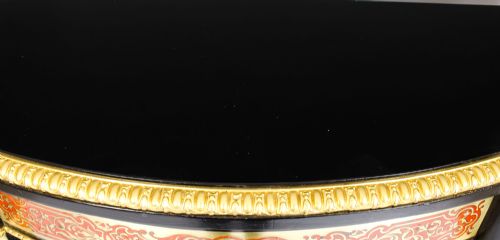 fig 1. A nineteenth-century ebonised serpentine credenza featuring brass and tortoiseshell Boulle marquetry, cast gilt-bronze ormolu mounts, a central panelled door, and glass display sides.
