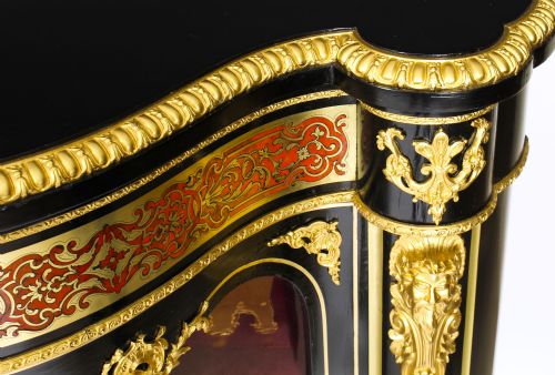 fig 5. A nineteenth-century ebonised serpentine credenza featuring brass and tortoiseshell Boulle marquetry, cast gilt-bronze ormolu mounts, a central panelled door, and glass display sides.