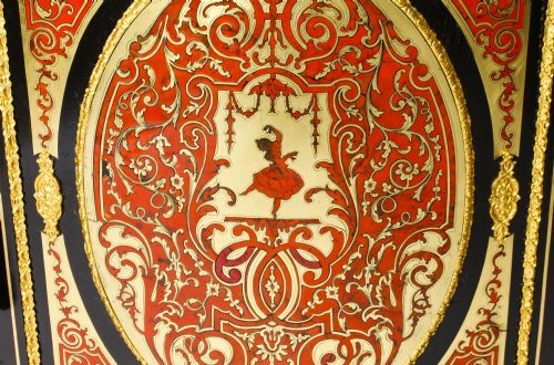 fig 6. A nineteenth-century ebonised serpentine credenza featuring brass and tortoiseshell Boulle marquetry, cast gilt-bronze ormolu mounts, a central panelled door, and glass display sides.
