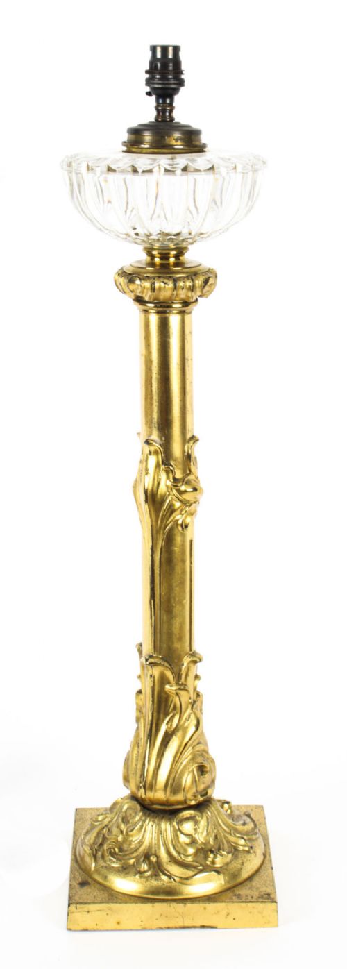 fig 1. An antique William IV gilt bronze table lamp featuring a column base with carved acanthus foliage and a cut glass bowl below the fitting.