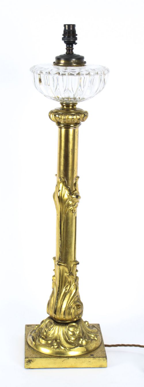 fig 2. An antique William IV gilt bronze table lamp featuring a column base with carved acanthus foliage and a cut glass bowl below the fitting.