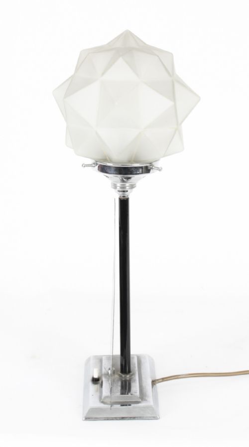 fig 4. An Art Deco chrome table lamp featuring a stylized sailboat stem set upon a stepped rectangular base, topped with a faceted frosted glass shade.