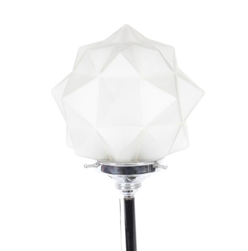 fig 5. An Art Deco chrome table lamp featuring a stylized sailboat stem set upon a stepped rectangular base, topped with a faceted frosted glass shade.