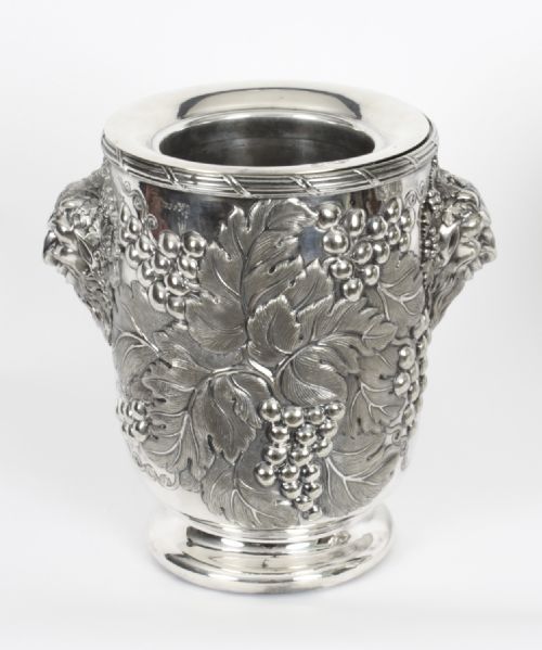 fig 2. A pair of nineteenth-century silver-plated wine coolers featuring relief grapevines and side handles on pedestal bases.