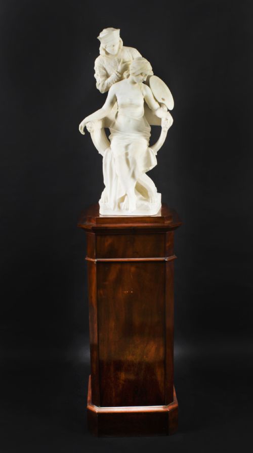 fig 1. A 19th-century white carved alabaster sculpture depicting a seated female figure in drapery with a male figure standing behind her.
