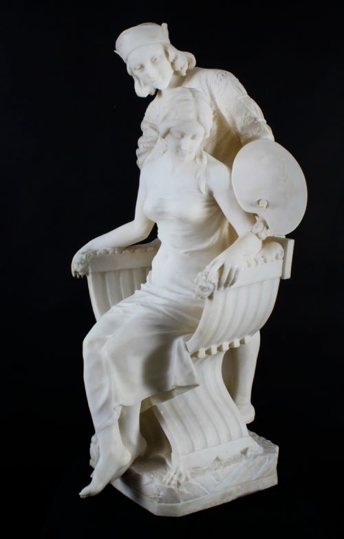 fig 2. A 19th-century white carved alabaster sculpture depicting a seated female figure in drapery with a male figure standing behind her.