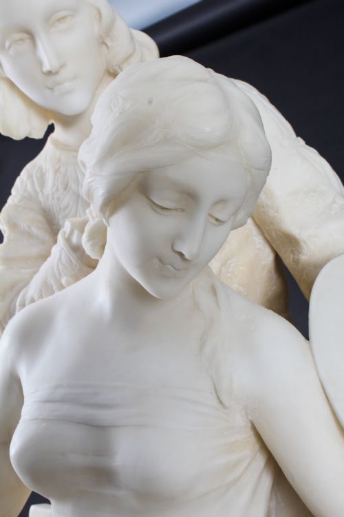 fig 3. A 19th-century white carved alabaster sculpture depicting a seated female figure in drapery with a male figure standing behind her.