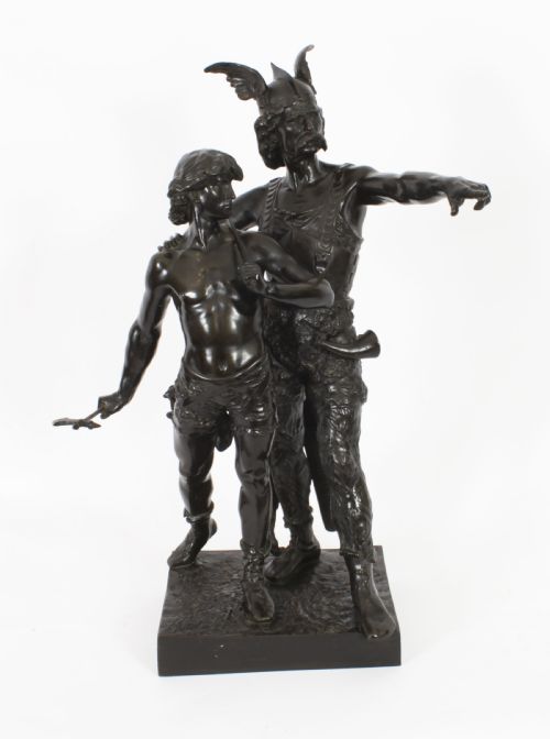fig 1. A 19th-century dark patinated bronze sculpture depicting a standing Gaulish warrior with a winged helmet pointing forward next to a young boy holding an axe on a rectangular base.