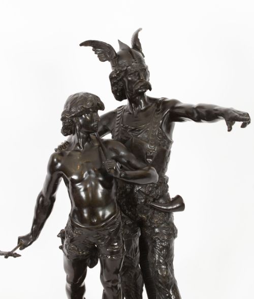 fig 2. A 19th-century dark patinated bronze sculpture depicting a standing Gaulish warrior with a winged helmet pointing forward next to a young boy holding an axe on a rectangular base.