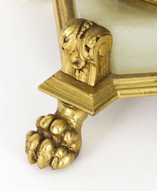 fig 7. A 19th-century French Sevres-style porcelain urn lamp painted with cherubs, featuring gilt bronze handles, foliage mounts, and an onyx base.