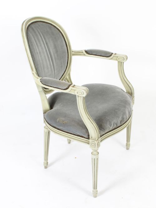 fig 2. A pair of early 20th-century French Louis XVI Revival armchairs with off-white painted frames, oval backs, and grey velvet upholstery.
