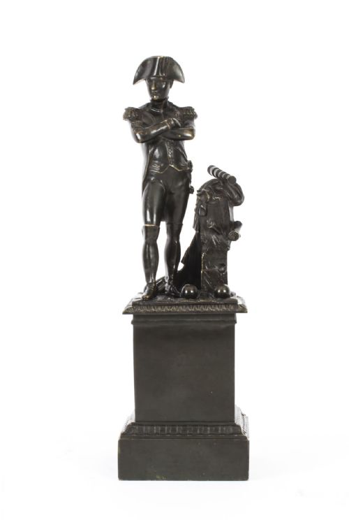 fig 3. A nineteenth-century dark patinated bronze statuette depicting Napoleon Bonaparte in military attire standing upon a rectangular bronze plinth.