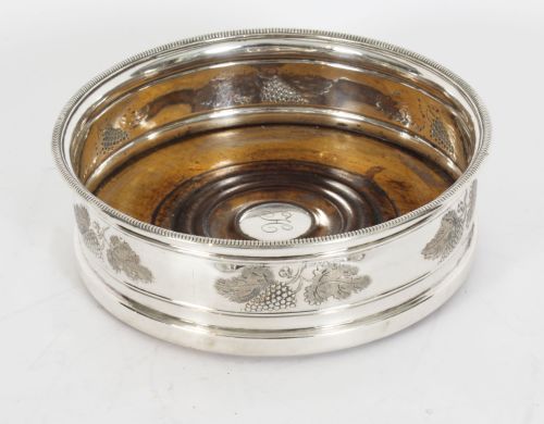 fig 2. A set of four circular Regency period Old Sheffield Plate wine coasters with turned wooden bases and foliage chased silver rims.