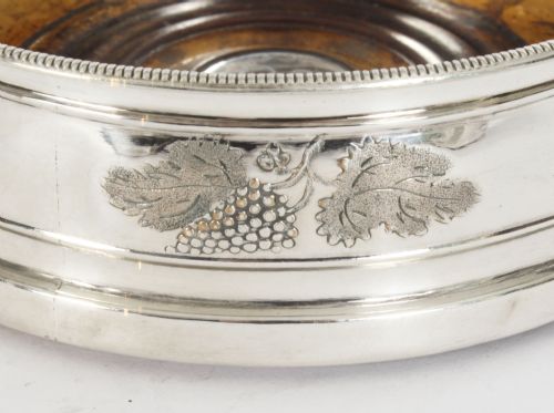fig 3. A set of four circular Regency period Old Sheffield Plate wine coasters with turned wooden bases and foliage chased silver rims.
