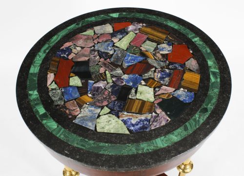 fig 1. A circular early 20th-century Italian occasional table featuring a colourful pietra dura inlaid stone top supported by three brass columns on a mahogany triform base.